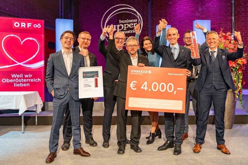 Ein Teil des Projektteams von Primetals Technologies jubelt über den 3d-zahnraeder-paul-wurth-trockenreformierungstechnologiespreis.